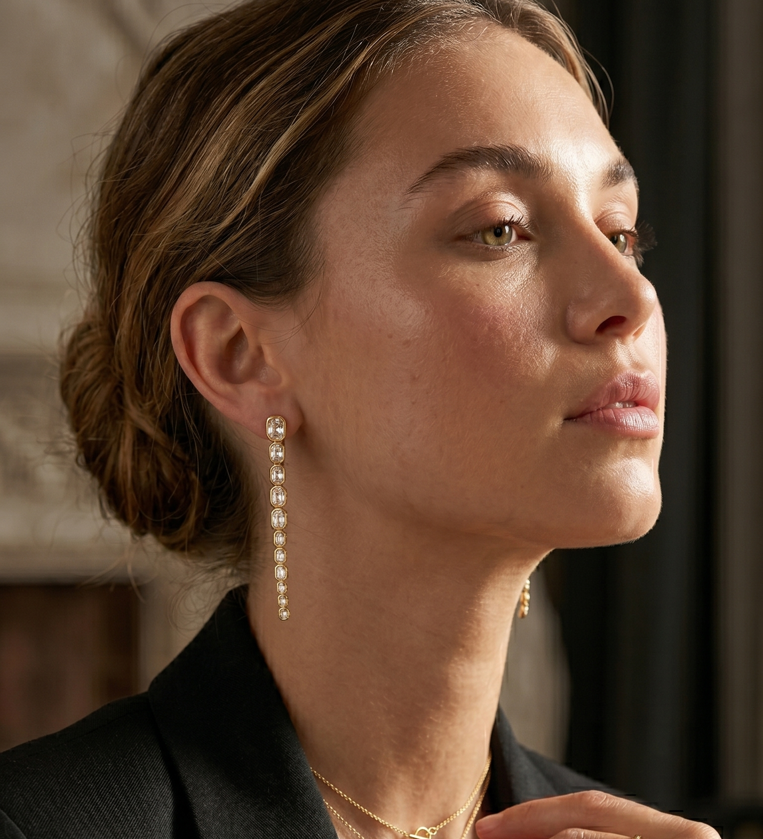 woman with long gold plated earrings