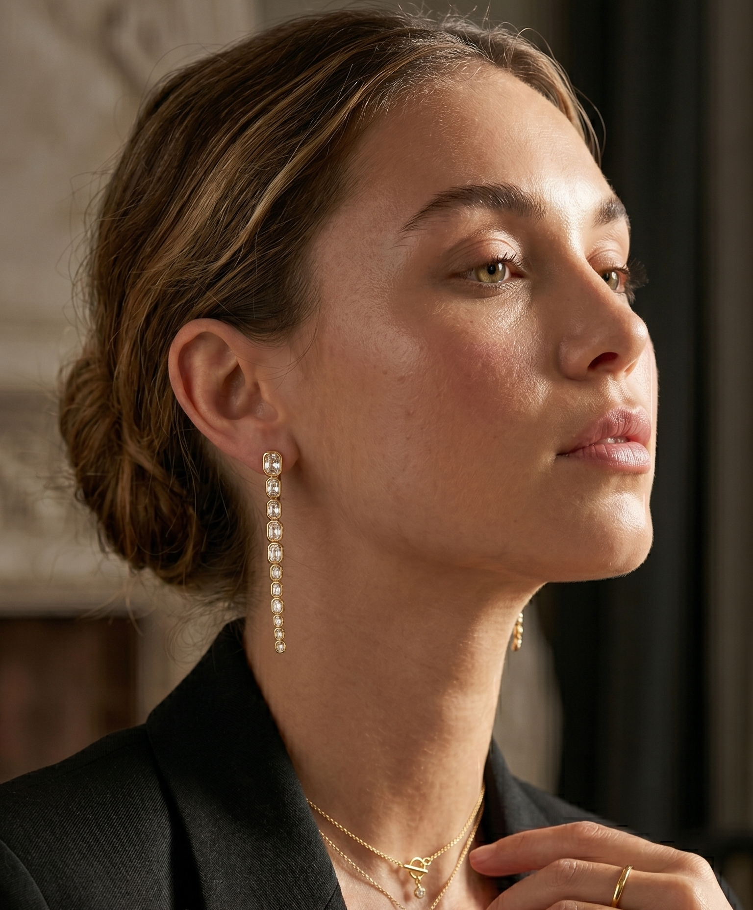 woman with long gold plated earrings